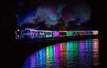 Train of Lights reflecting in the water, Paignton to Dartmouth Steam Railway, Paignton, Devon