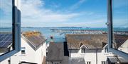 Old Ice House, Brixham holiday accommodation. View from open window over rooftops and to the marina and sea.