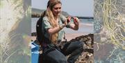 Coast to Caves event, part of England's Seafood FEAST. Forager Flora on a beach.