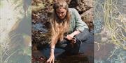 Coast to Caves event, part of England's Seafood FEAST. Forager Flora on a beach.