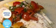 A prepared dish of fresh fish with tomato at Portofino restaurant, Wellswood, Torquay. Part of England's Seafood FEAST.