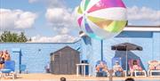 Kids playing with inflatable ball in the outdoor pool
