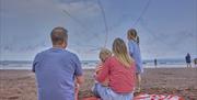 Family watching the Red Arrows at the English Riviera Airshow