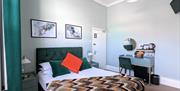 Beautiful double bedroom with jade green furniture