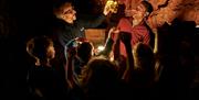 Prehistoric Humans being shown in Kents Cavern Caves
