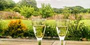 Wine glasses and view of garden at Elberry Farm self-catering property