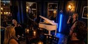 images of the trio performing and a selection of food from the menu