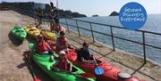 Kayaks waiting to be launched, Geology, Wildlife and Cave Kayak Tour - Sea Kayak Torbay