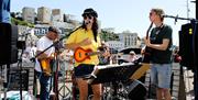 Musicians outside Offshore, Torquay harbourside