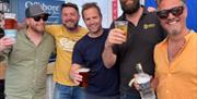 Men having a drink outside Offshore, Torquay harbourside