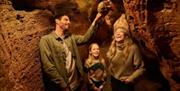 Family taking part in Kents Cavern Discovery Evenings