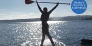 Person standing on a paddleboard, Coastal Paddleboard Adventure, Reach Outdoors