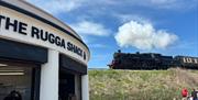 Exterior of Rugga Shack with the steam train in the background