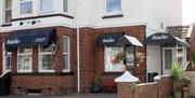photos of the breakfast room, bedrooms and outside of Beaches Guest House Paignton