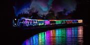 Train of Lights reflecting in the water, Paignton to Dartmouth Steam Railway, Paignton, Devon