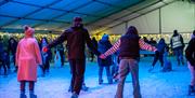 Skaters holding hands on Torquay Ice rink
