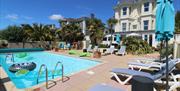 Pool with inflatables and sun terrace, with loungers