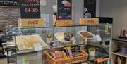 Central Caffe Front Counter Featuring Sweet treats and Pricing Torquay in Devon