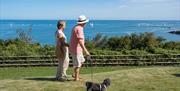 Couple looking across St Mary's Bay from Riviera Bay Coastal Retreat