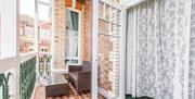 Atherfield Holiday Apartments, patio doors opening onto tiled balcony with seating area