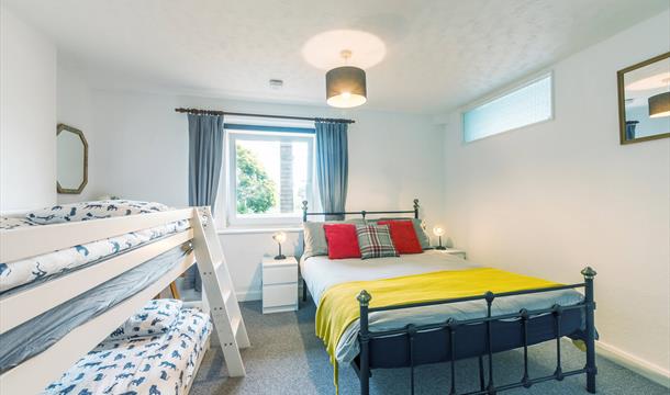 Atherfield Holiday Apartments, bedroom with double bed and bunk beds