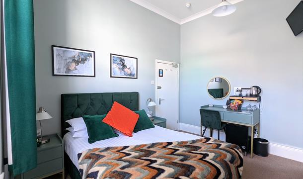 Beautiful double bedroom with jade green furniture