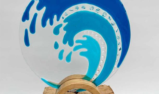 Blue glass wave held in place by wood