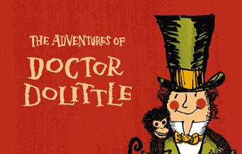 Doctor Dolittle in top hat surrounded with animals.