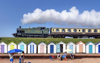 Steam locomotive Goliath over the beach huts at Goodrington Sands