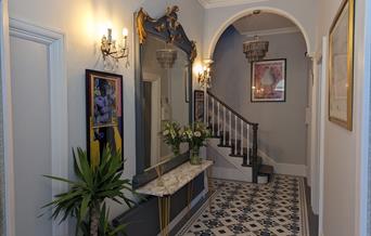 Hallway with contemporary artwork and beautiful tiles flooring.