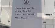 Poster encouraging to take a photo to avoid paper waste in the English Riviera Visitor Information Centre on Torquay harbourside.