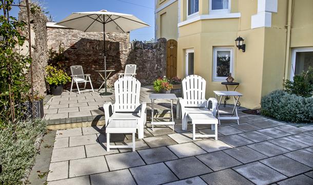 Sunloungers and patio table at Court Prior, Torquay, Devon