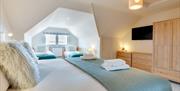 Old Ice House, Brixham holiday accommodation. Double bedroom with view from window to sea.