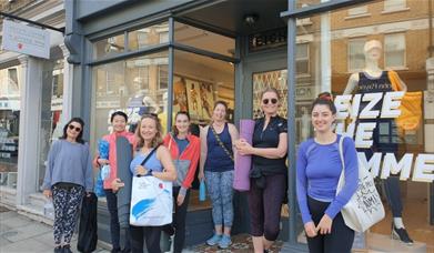 Sweaty Betty Blackheath. Showing a group of people outside the shop with Sweaty Betty products.