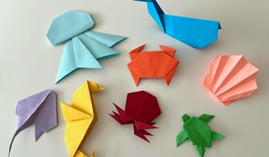 A relaxed, multi-generational session where participants create individual pieces using simple origami, collage and card-making within a shared theme.