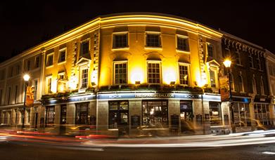 Night view of the historic 19th century building well lit up at one corner of the Greenwich Market.