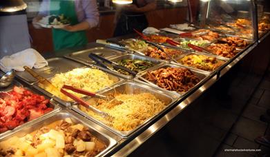 Inside China City Woolwich showing a buffet table filled with food.