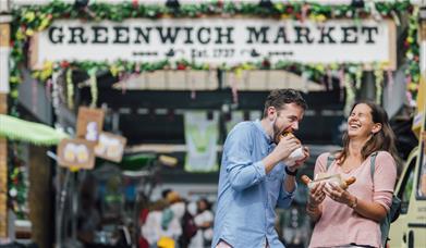 A couple enjoying their food at Greenwich Market Food Court