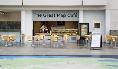 The Great Map Café, located inside the National Maritime Museum. In the picture you can see the café with a range of treats and lots of seating.