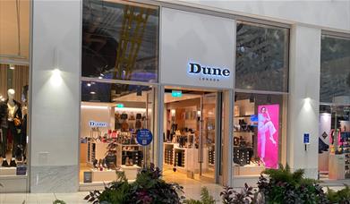 Dune at the O2. A stunning square shaped shop with a black and white design. Inside the windows are an amazing collection of footwear.