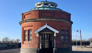 A guard house looking, red brick Woolwich Foot Tunnel entrance.