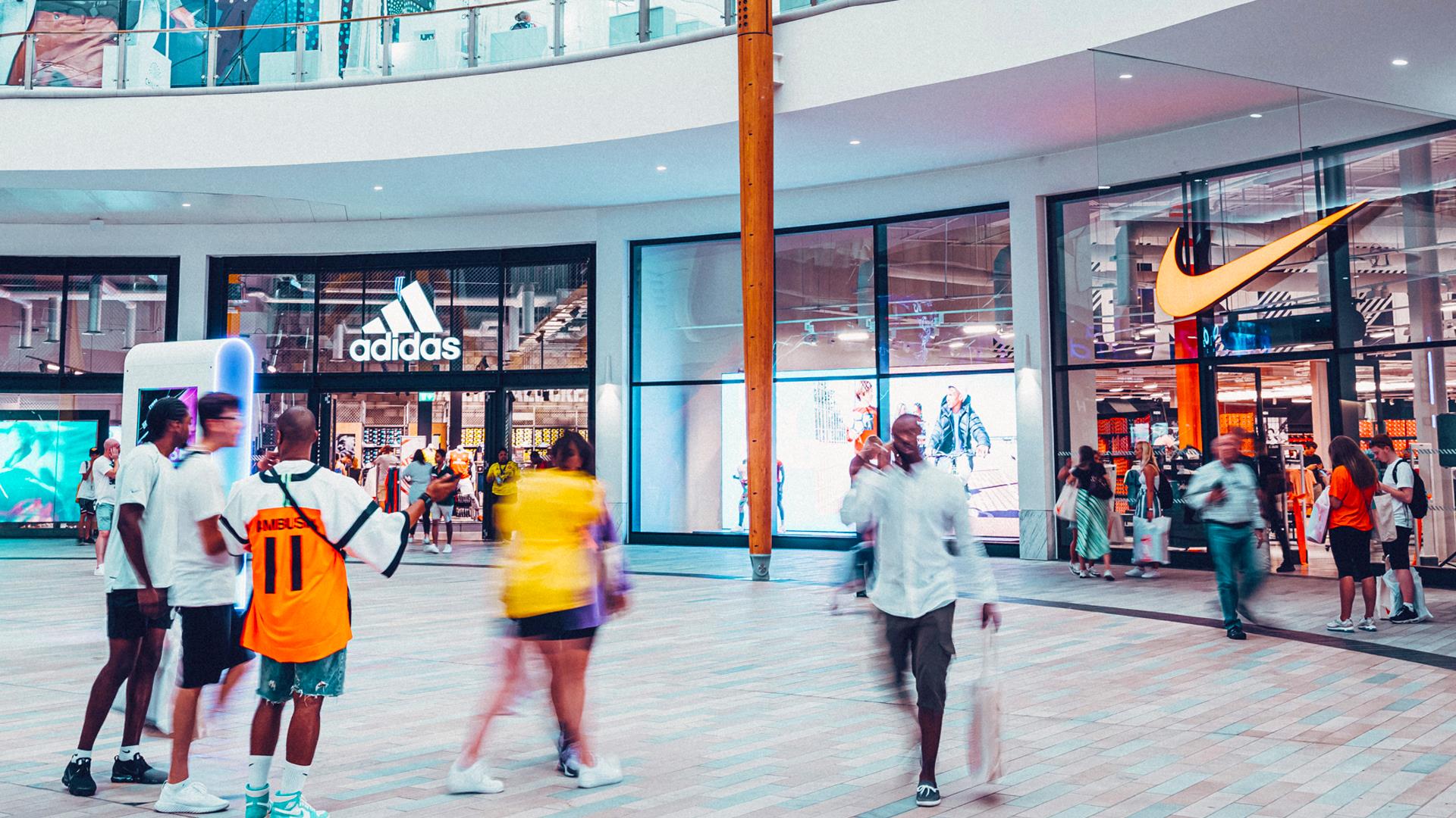 A group of people in ICON Outlet shopping centre in The O2, Greenwich.