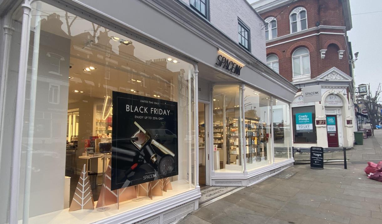 Outside Space NK in Blackheath. A stylish white and black shop front with a wonderful window display. In the display is decorations and some of the sh