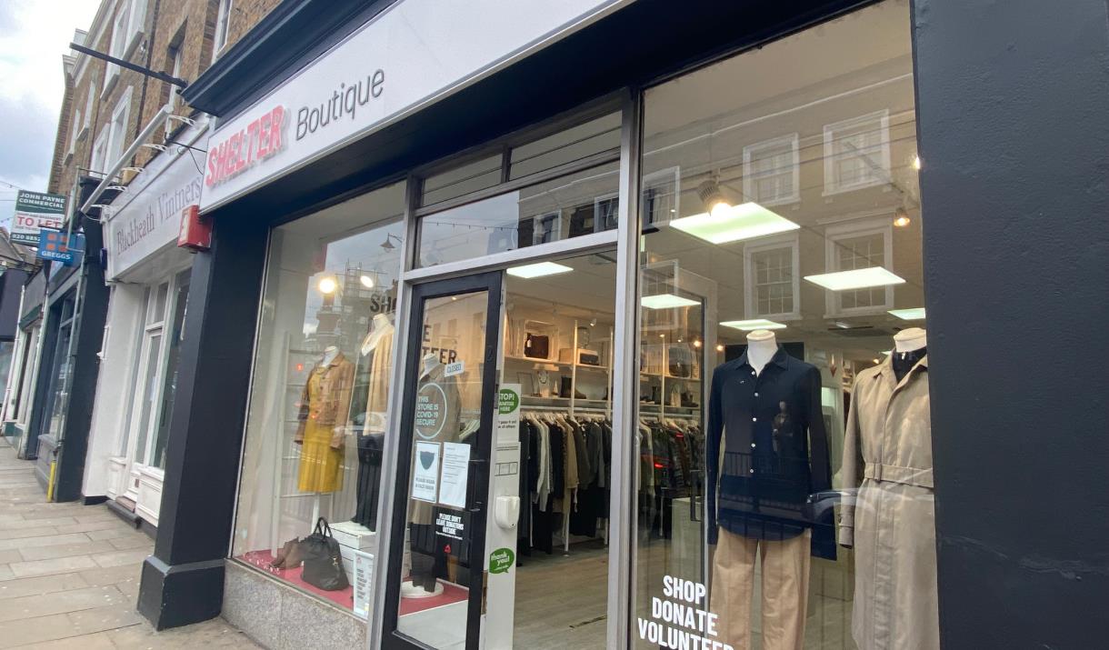 Outside Boutique by Shelter in Blackheath. A modern red, black and white charity shop. Inside is a wonderful selection of clothing.