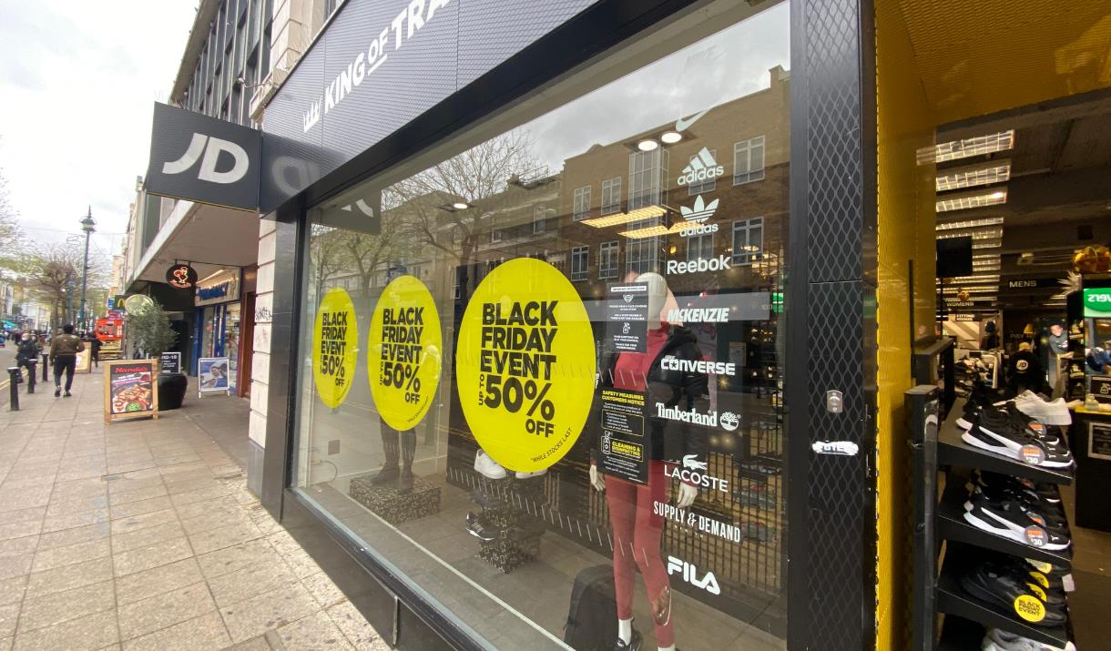 Outside JD Sports in Woolwich. A black, white and yellow themed shop with a great selection of items.