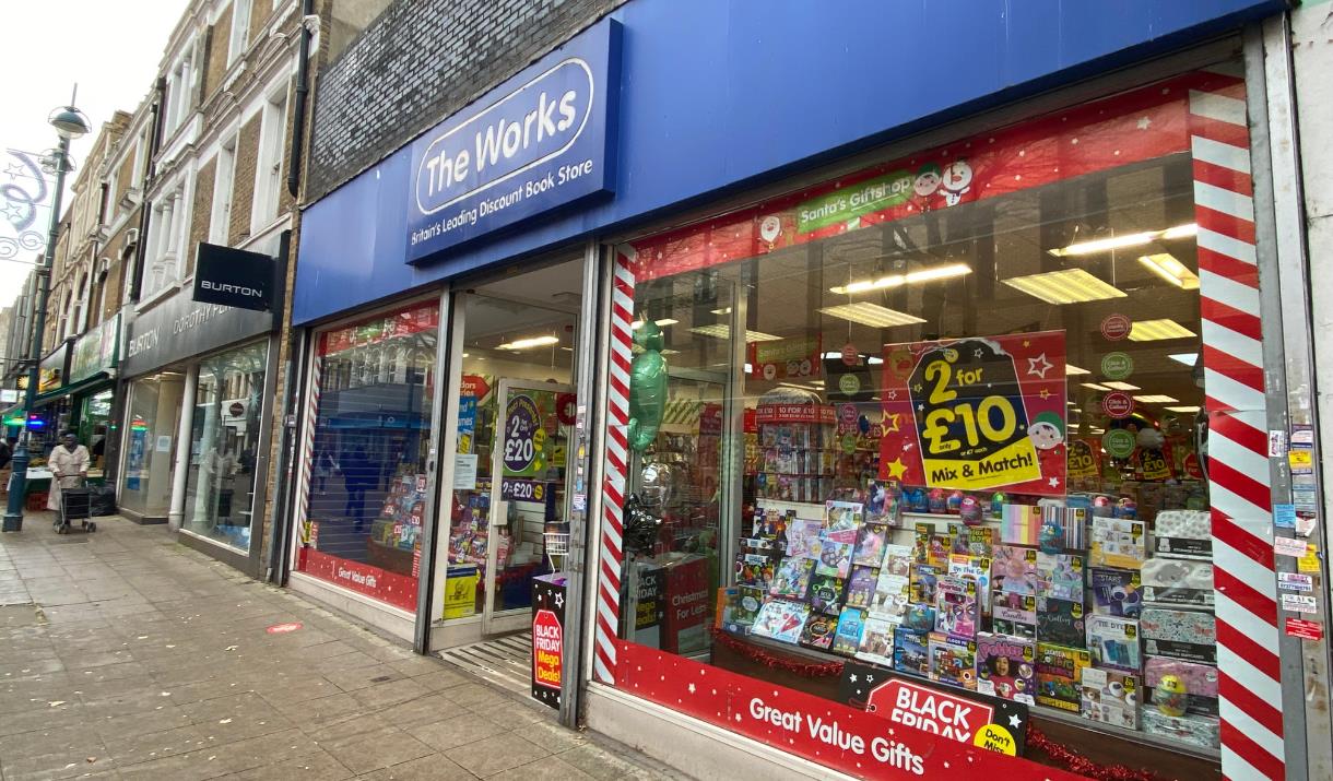 Outside The Works in Woolwich. Showing a blue and white shop front with a range of exciting products inside waiting to be found.