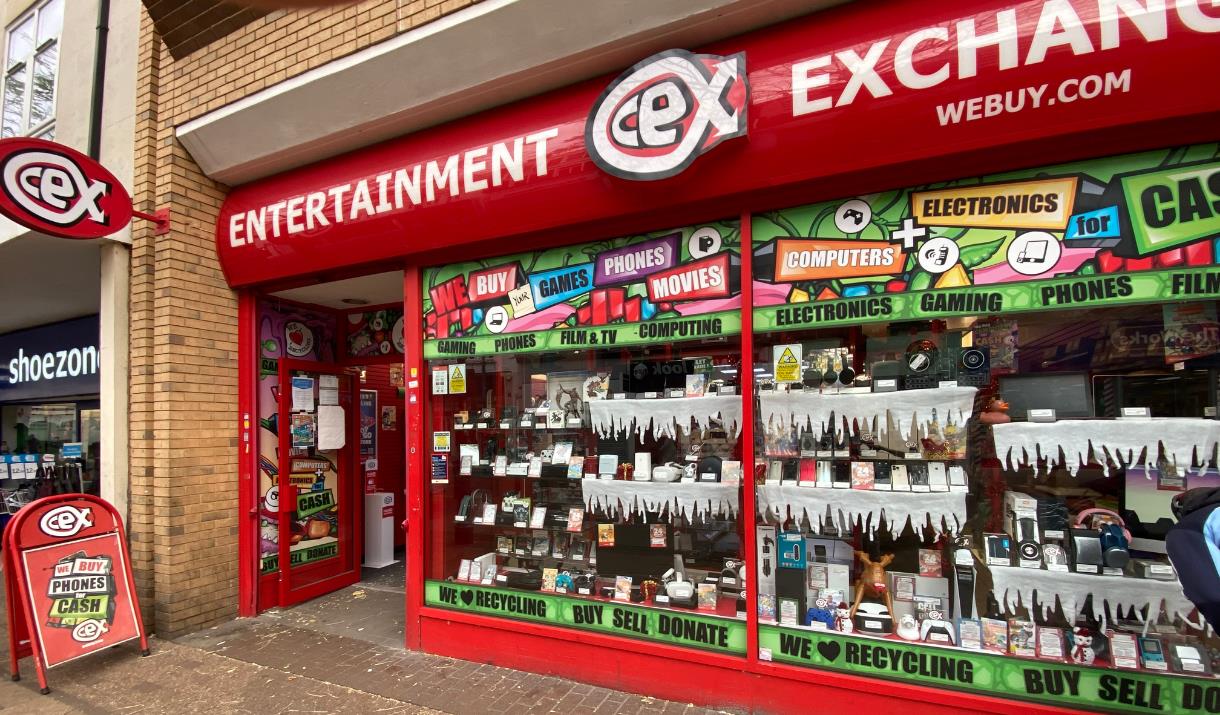 Outside CeX in Greenwich. A red shop front filled with electrical products.