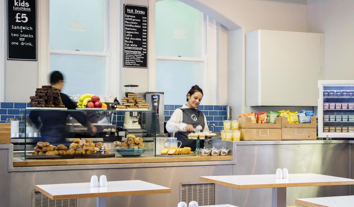 Astronomy Café, showing a counter with a range of delicious foods and drinks. As well as tables for you to sit and relax.