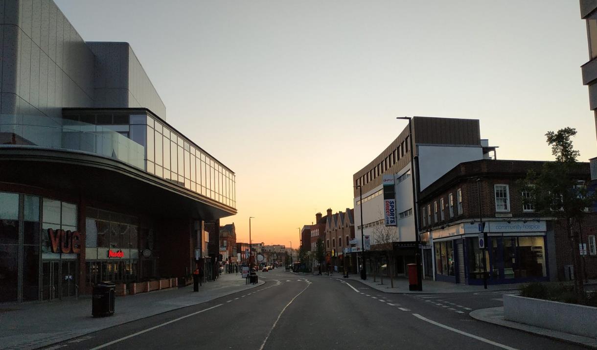 Eltham High Street on a lovely sunset evening, showing a long road filled with shops, entertainment and more.