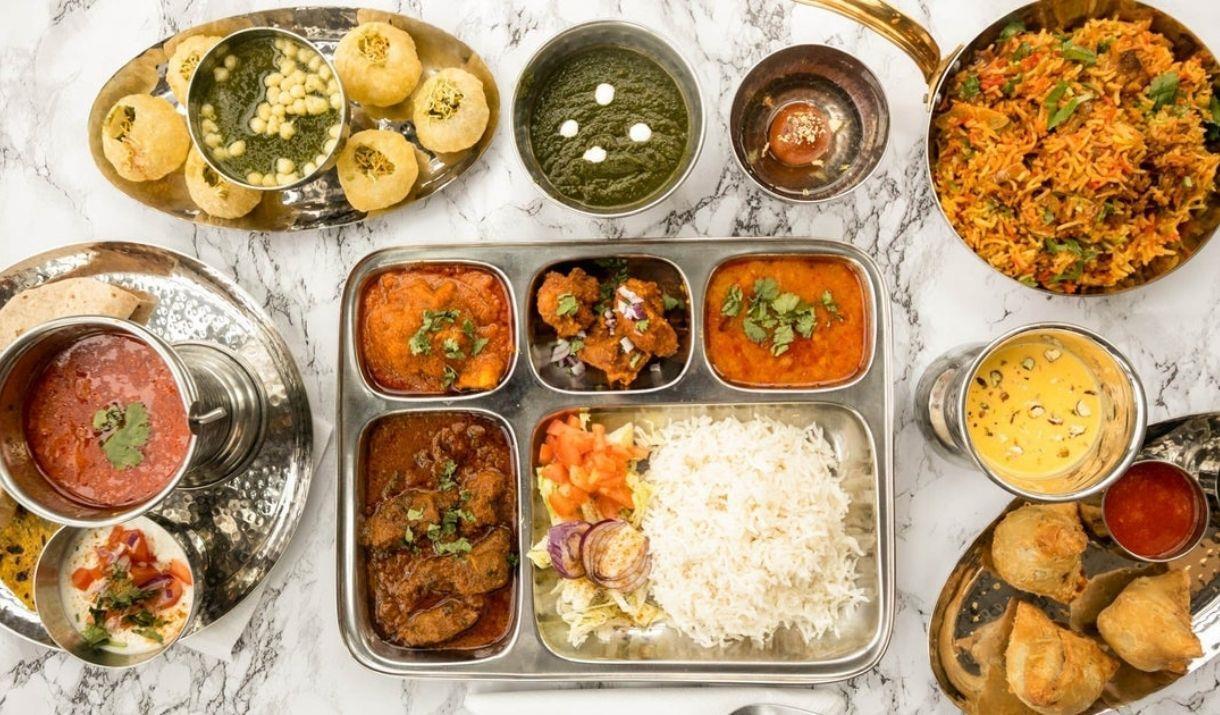 A table filled with Indian cuisine, at Hullabaloo Greenwich.